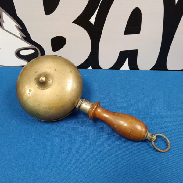 Vintage brass hand bell with wooden handle, antique collectible.