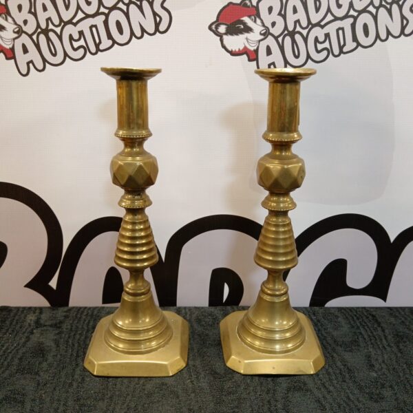 Vintage Arabic brass candlesticks with hexagonal bases and fluted stems.