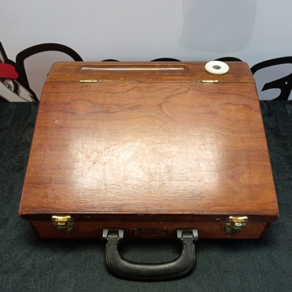 Front view of antique wooden writing slope with handle.