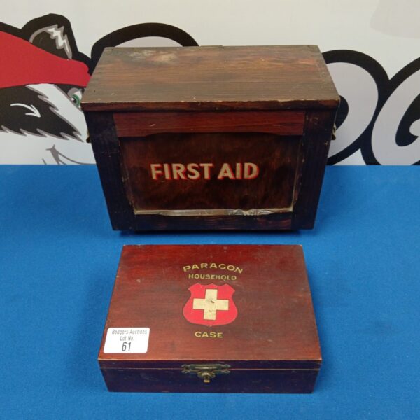 Vintage wooden first aid box with "FIRST AID" painted on the front.