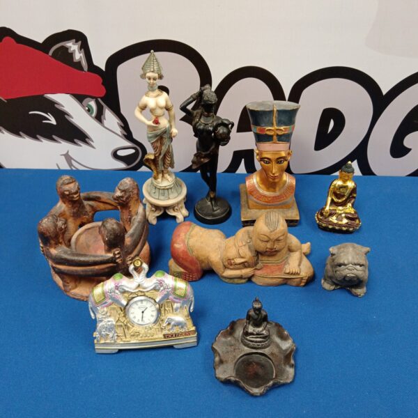 Diverse collection of stone and pottery sculptures, including a Buddha.