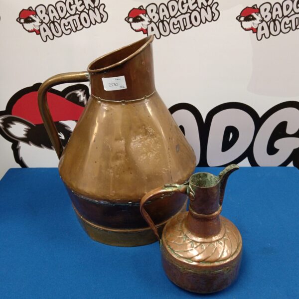 Antique copper pitcher with curved handle and spout.