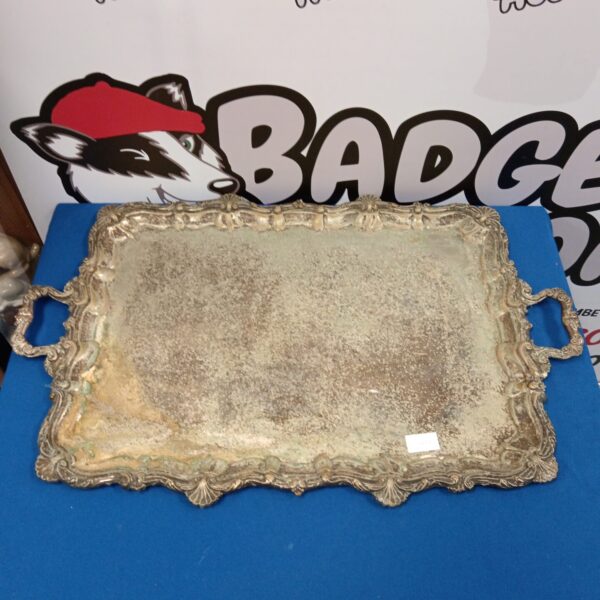 Ornate antique silver plate serving tray with detailed border.