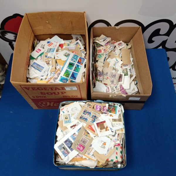 Worldwide stamp collection in cardboard boxes and a tin.