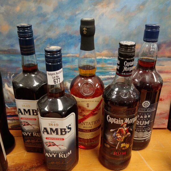 Lot of five vintage rum bottles, including Lambs and Captain Morgan.