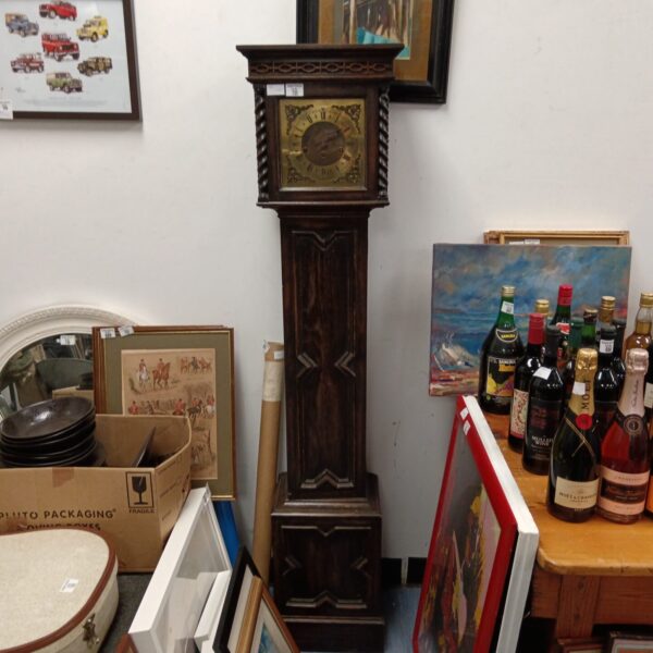 Antique oak granddaughter clock with pendulum, vintage timepiece.