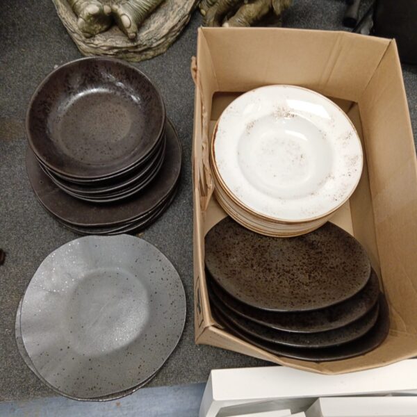 Stack of rustic Steelite plates and bowls for restaurant use.