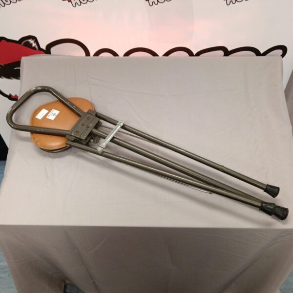 Vintage shooting stick with leather seat for outdoor support.