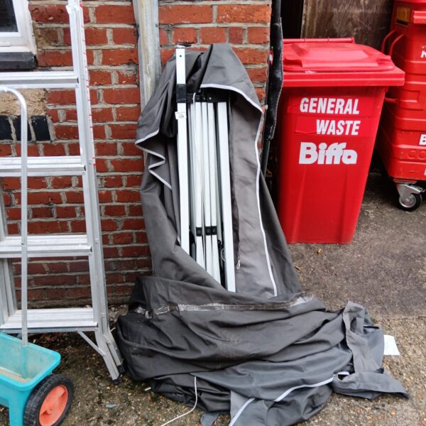 Dark grey heavy-duty gazebo in a garden setting.