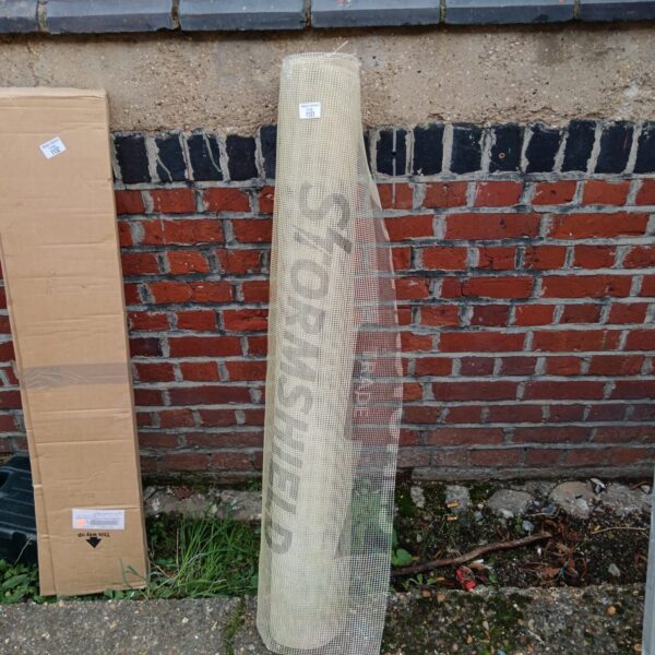 Roll of storm shield mesh for garden plant protection.