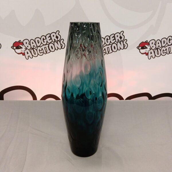 Large blue art glass vase with flowing form.