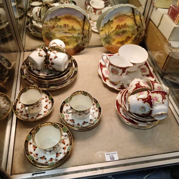 Vintage china teaset collection with floral patterns and saucers.