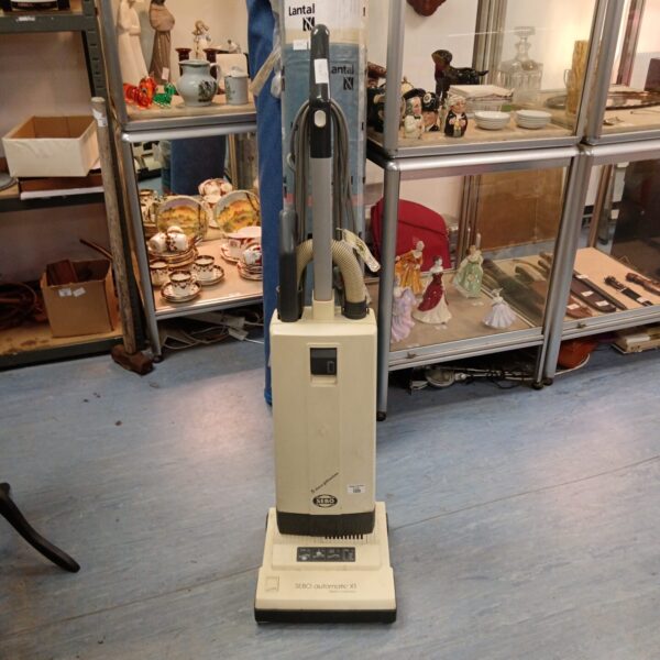 Sebo Automatic X1 upright vacuum cleaner in a shop setting.