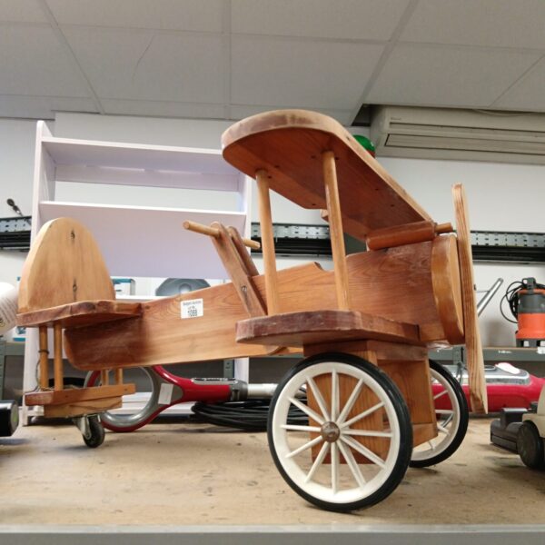 Vintage wooden ride-on plane, a charming collectible toy.