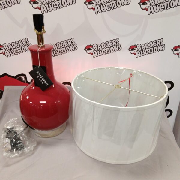 Vibrant red Safavieh table lamp with modern design.