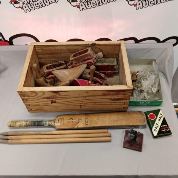 Vintage wooden toys and cricket bat in a wooden box.