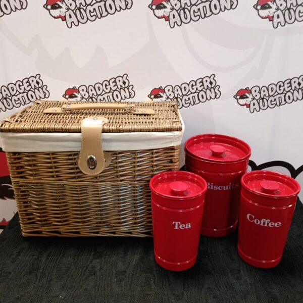 Vintage wicker hamper with red tea and coffee tins.