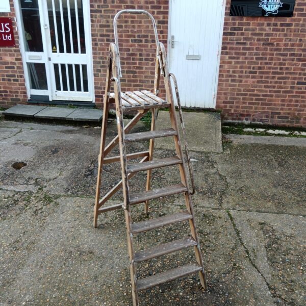 Vintage wooden step ladder with seven steps, rustic farmhouse style.