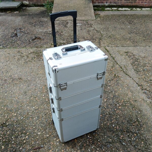 Silver aluminium transit case with wheels and pull handle.
