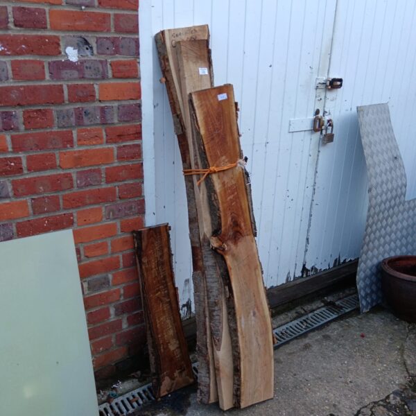 Lot of four seasoned cherry wood planks for woodworking projects.