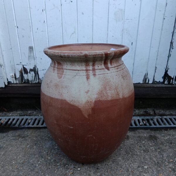 Large weathered terracotta pottery urn planter for garden display.