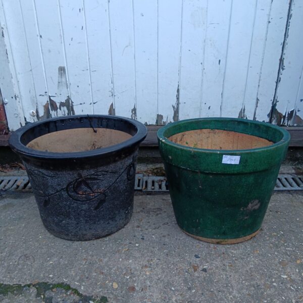Vintage black and green pottery planters for garden decor.