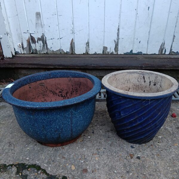 Two blue glazed garden pots with ribbed texture.