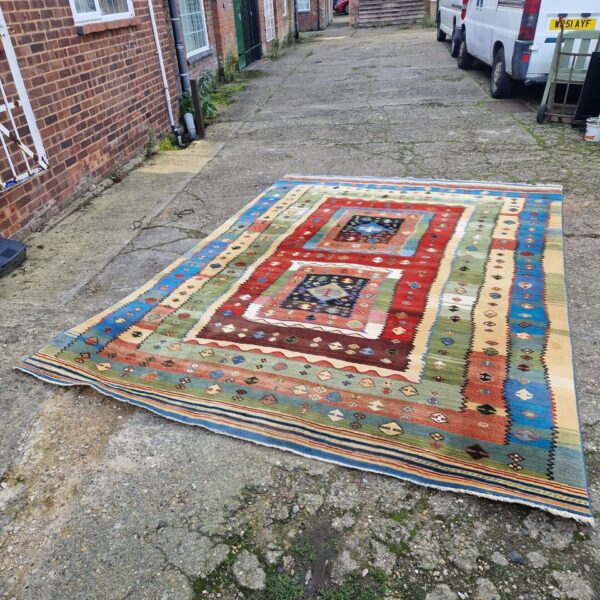 Vibrant colourful Aztec style rug for living room floor.