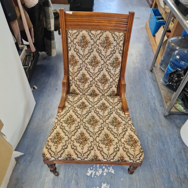 Floral upholstered Victorian nursing chair with wheels.