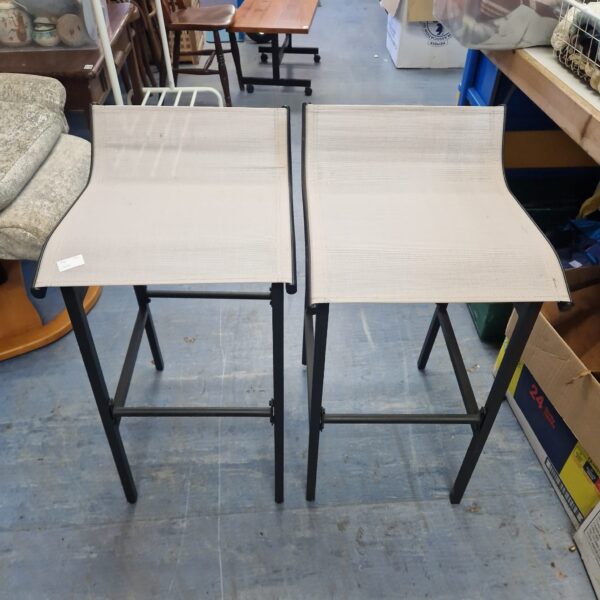 Pair of vintage metal kitchen stools with industrial design.