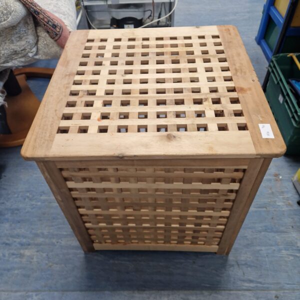 Vintage wooden laundry basket with slatted sides for rustic storage.