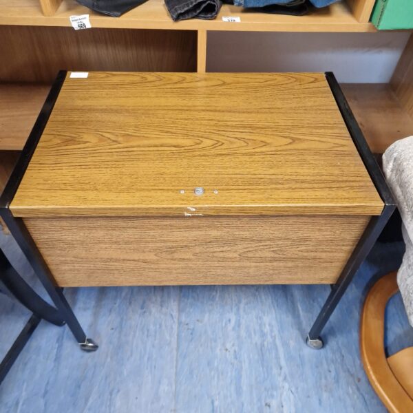 Vintage wheeled filing cabinet with wood veneer and metal frame.