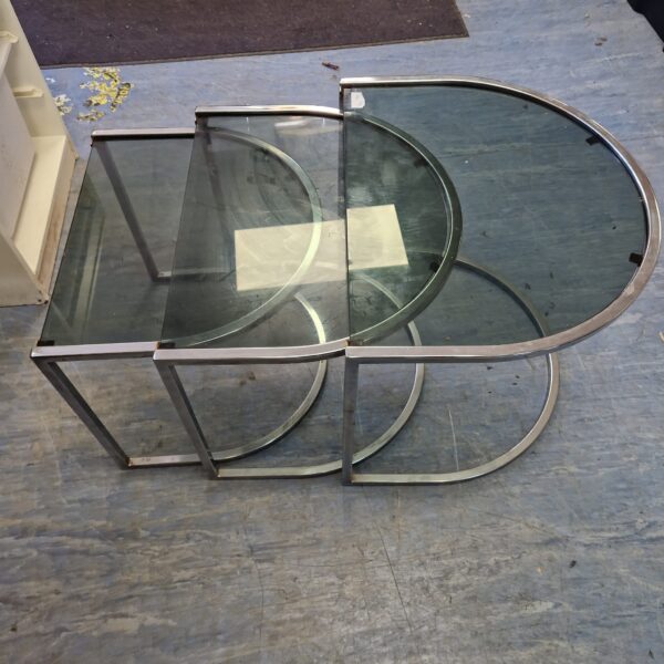 Vintage nest of three glass and chrome tables in a retro style.