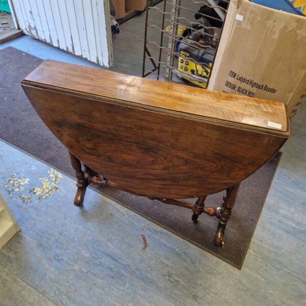 Antique Victorian drop leaf table with turned legs.