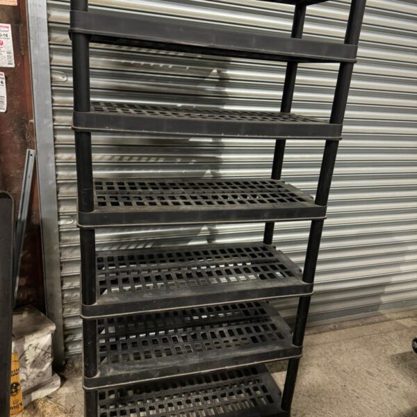 Black plastic 7 tier shelving unit for storage.