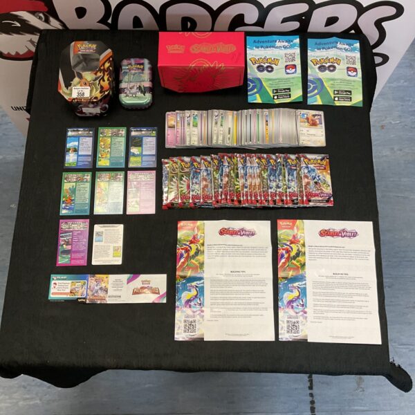 Pokemon card collection with tins and booster packs for collectors.