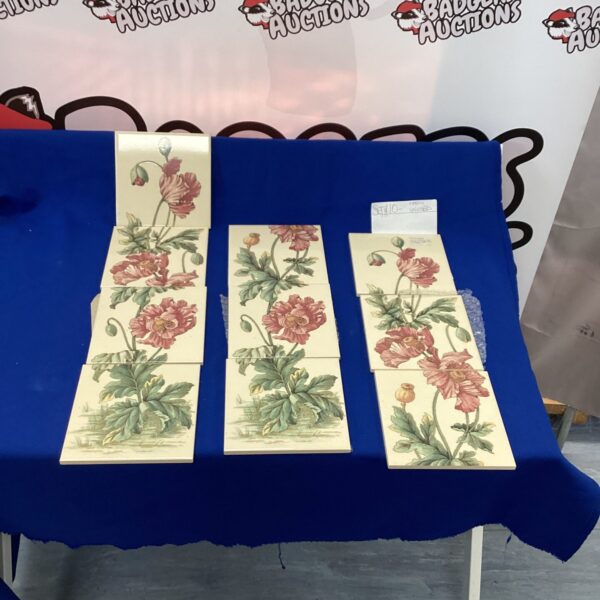 Lot of ten antique ceramic poppy fireplace tiles.