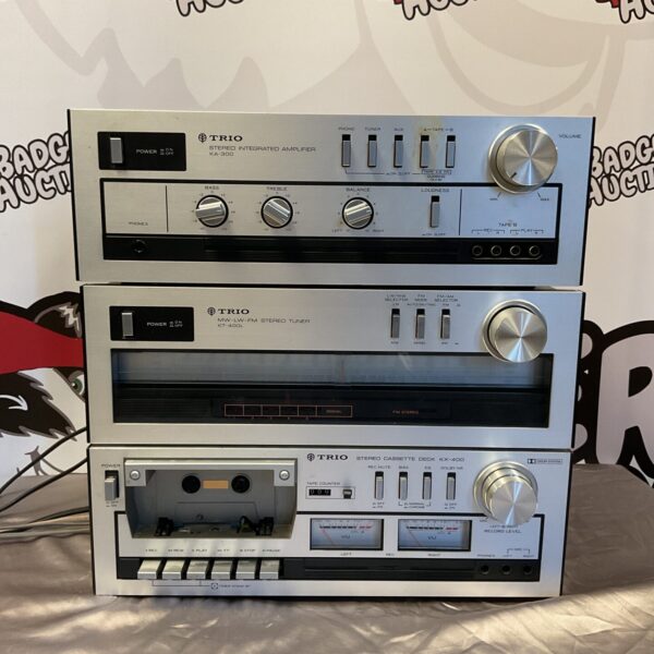 Vintage Trio hifi system stack including amplifier, tuner and cassette deck.