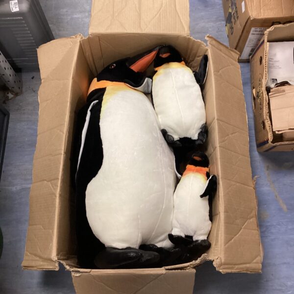 Lot of three soft plush penguins in a cardboard box.