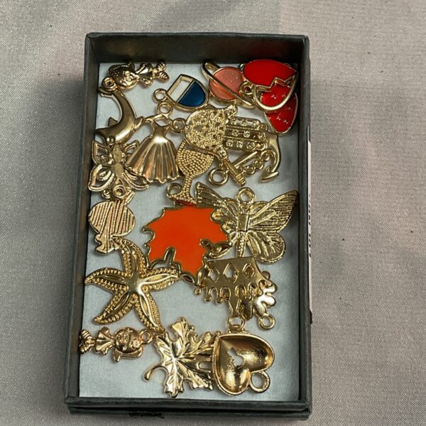 Vintage gilt metal pendants in a collection, miniature charms.