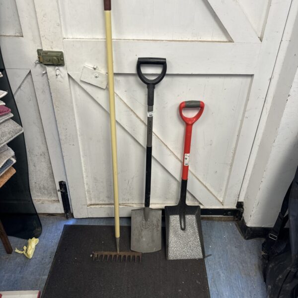 Garden tools lot including two shovels and a rake.