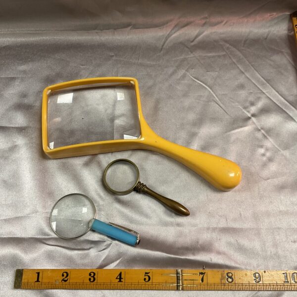 Yellow handled vintage magnifying glass, collectible optical instrument.