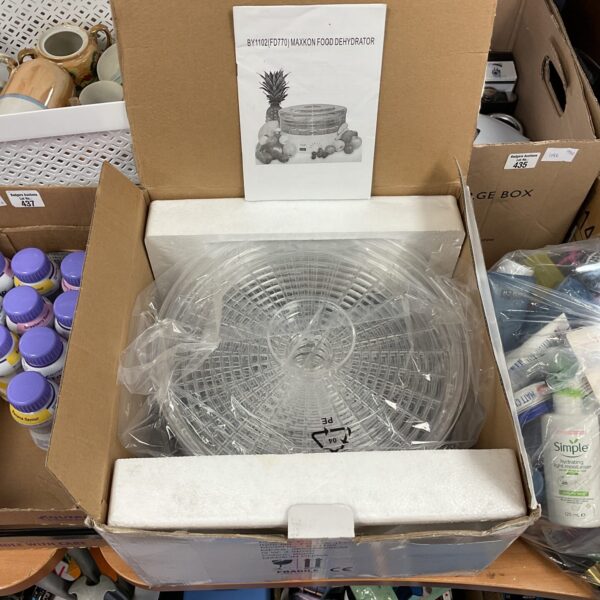 Maxkon food dehydrator trays stacked, vintage kitchen appliance.