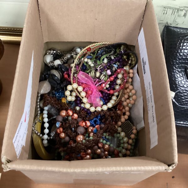 Assortment of vintage costume jewellery including necklaces and brooches.