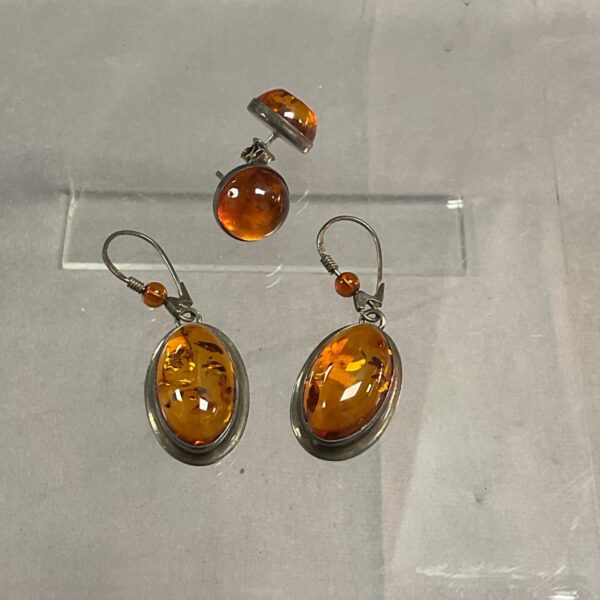 Close-up of two pairs of 925 silver amber earrings.