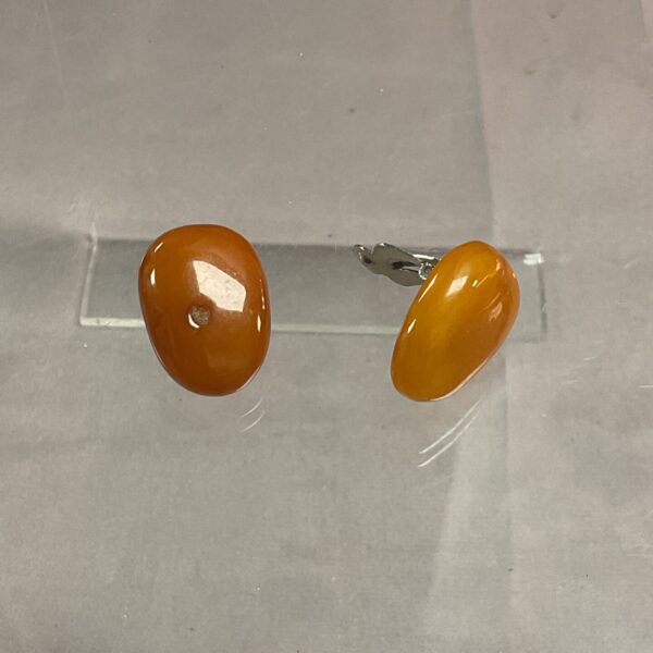 Close-up of vintage amber clip-on earrings, retro jewelry.