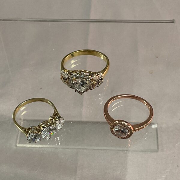 Silver gilt ring lot with white stones in varying sizes.