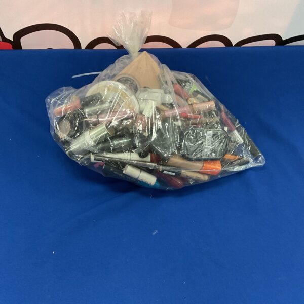 Mixed lot of unbranded beauty cosmetics in a plastic bag.