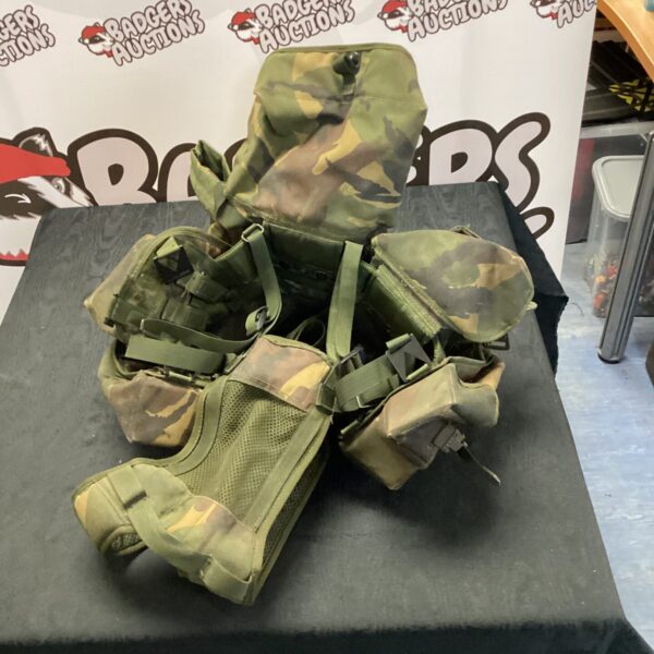 British military vest in woodland camo with multiple pouches.