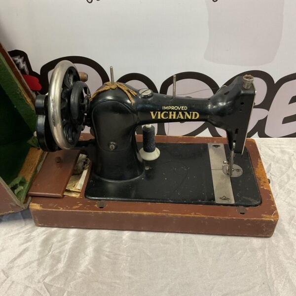 Vintage Vichand sewing machine with ornate details and black finish.